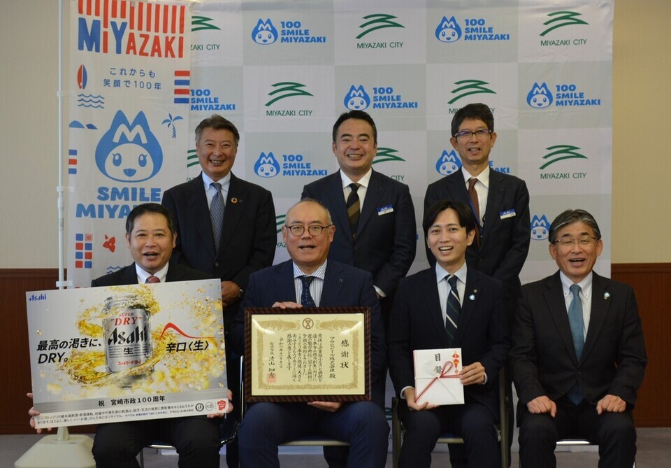 感謝状を手に持つ7人の集合写真